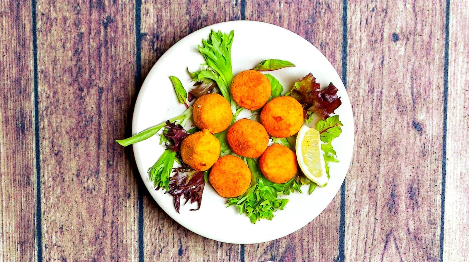Golden Brazilian bites served with greens and lemon
