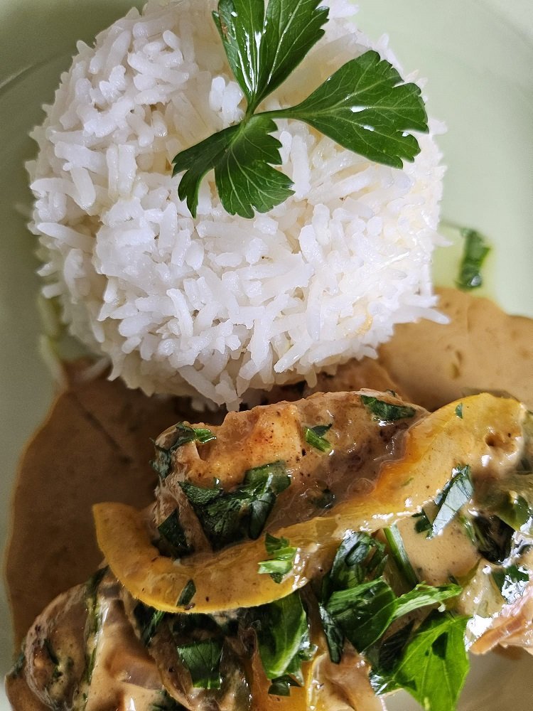 An Eduardo's grilled entrée plated with rice and fresh sides